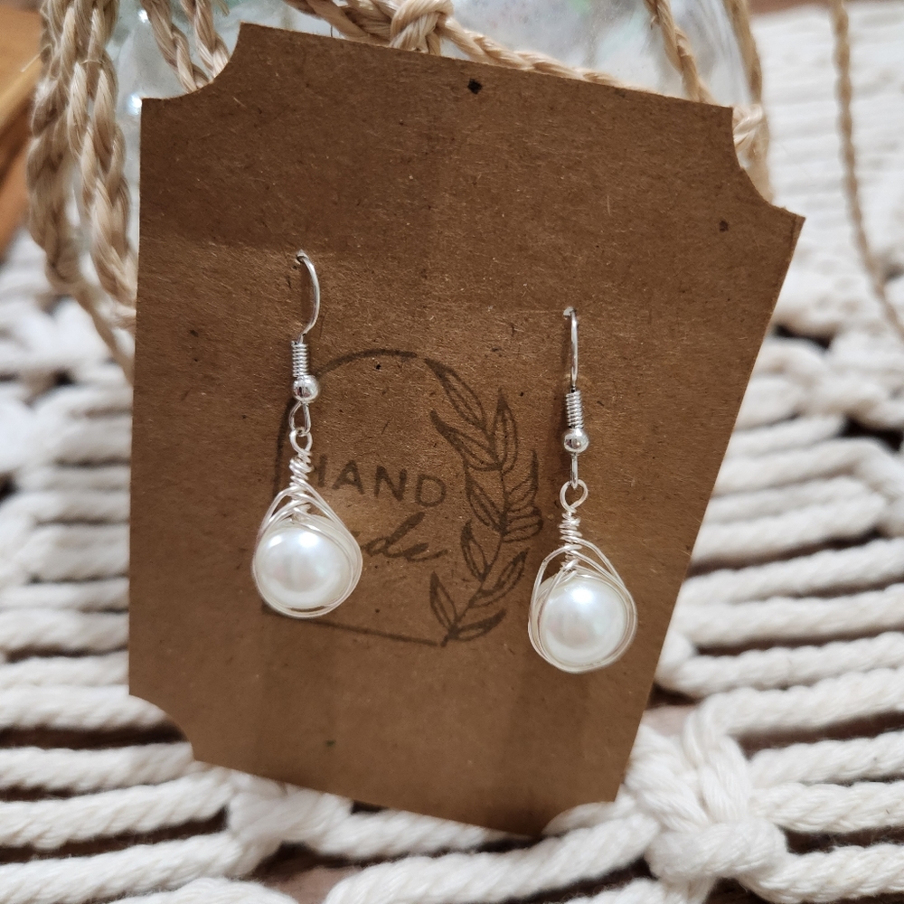 Silver accent with plastic pearl-like dangle earing